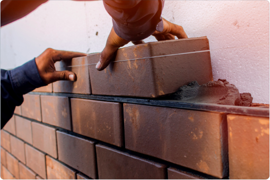 Bricklayer demonstrating skills during assessment
