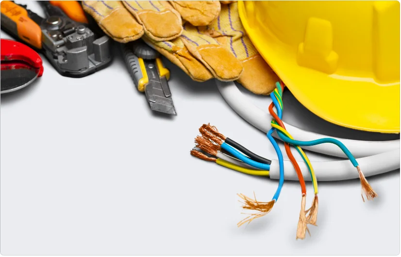 Electrician's mate assisting with wiring installation